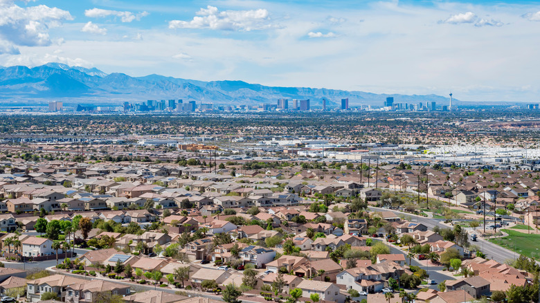 Aerial view of Las Vegas suburban neighborhoods with the Strip and mountains in the distance